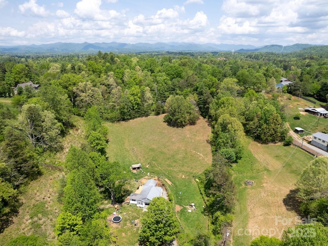 bird's eye view featuring a wooded view and a mountain view