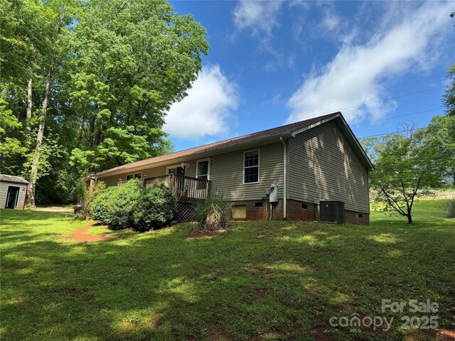 back of house featuring a yard, crawl space, and central AC