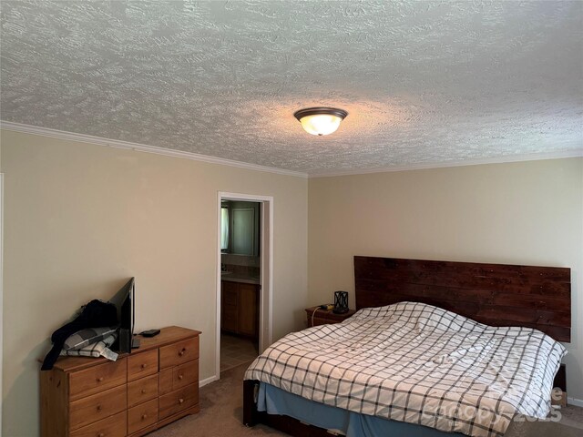 bedroom with carpet floors, ornamental molding, a textured ceiling, and baseboards