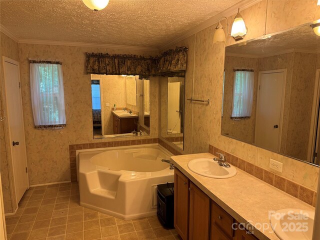 full bath featuring vanity, a textured ceiling, tile patterned floors, wallpapered walls, and a garden tub