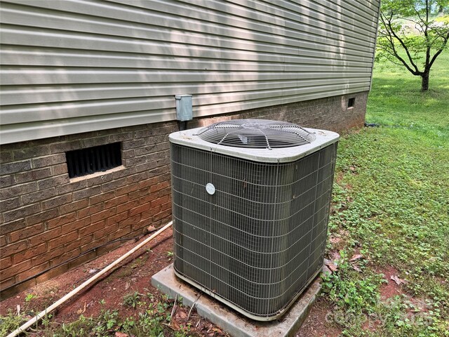 exterior details featuring central AC and crawl space