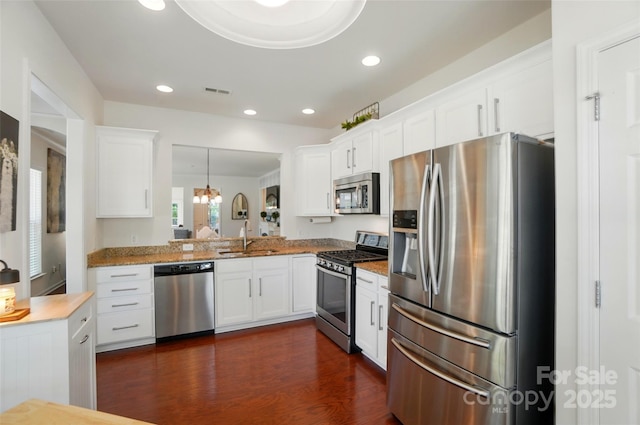 9003 Smokey Hill Ln, Fort Mill, SC 29707 - kitchen featuring appliances with stainless steel finishes, a sink, dark wood finished floors, white cabinetry, and recessed lighting