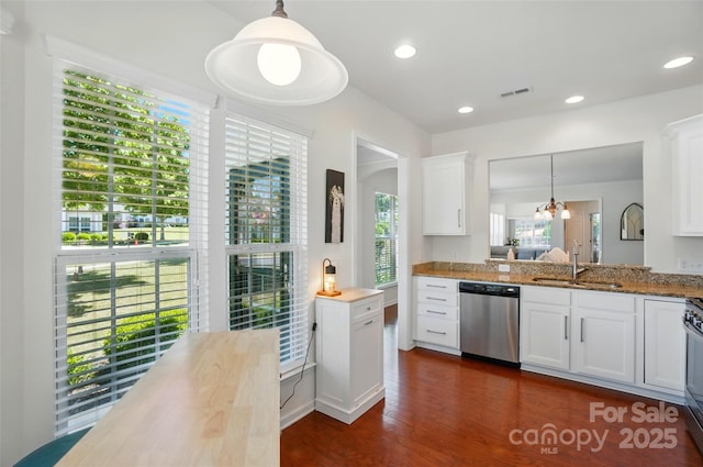9003 Smokey Hill Ln, Fort Mill, SC 29707 - kitchen with stainless steel appliances, a sink, white cabinets, dark wood-type flooring, and pendant lighting