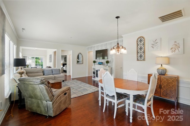 9003 Smokey Hill Ln, Fort Mill, SC 29707 - dining space featuring dark wood-style flooring, crown molding, and a chandelier