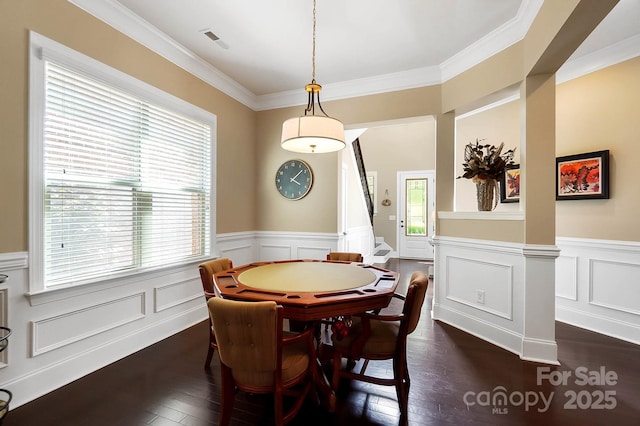 9735 Wheatfield Rd, Charlotte, NC 28277 - dining area with ornamental molding, a wainscoted wall, dark wood-style flooring, a decorative wall, and stairs