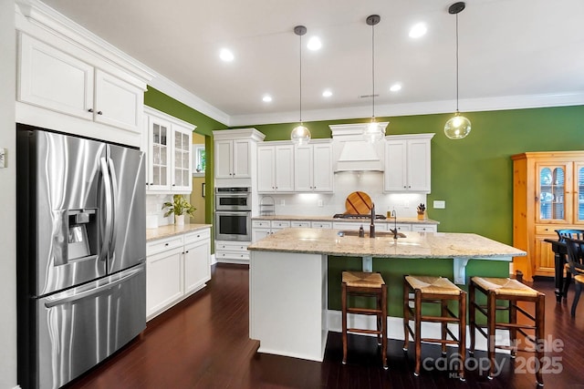 9735 Wheatfield Rd, Charlotte, NC 28277 - kitchen featuring appliances with stainless steel finishes, ornamental molding, custom exhaust hood, decorative backsplash, and white cabinets