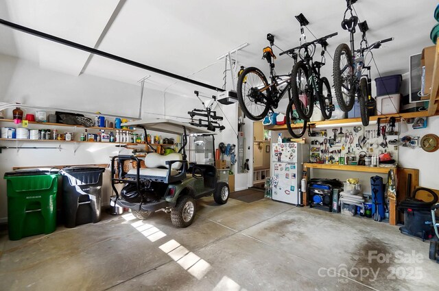9735 Wheatfield Rd, Charlotte, NC 28277 - garage with a workshop area, a garage door opener, and freestanding refrigerator
