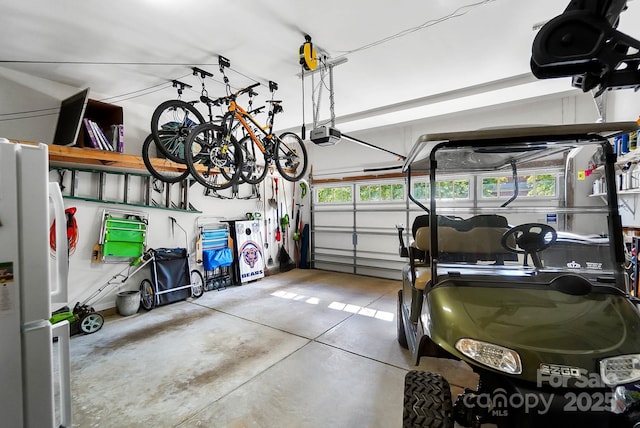 9735 Wheatfield Rd, Charlotte, NC 28277 - garage featuring a garage door opener and freestanding refrigerator