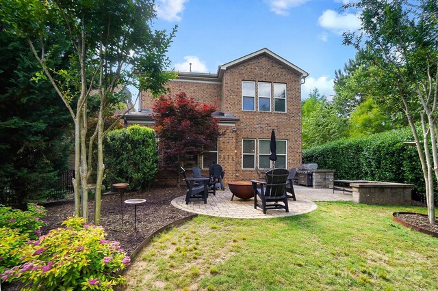 9735 Wheatfield Rd, Charlotte, NC 28277 - back of house with a patio area, brick siding, a lawn, and a fire pit