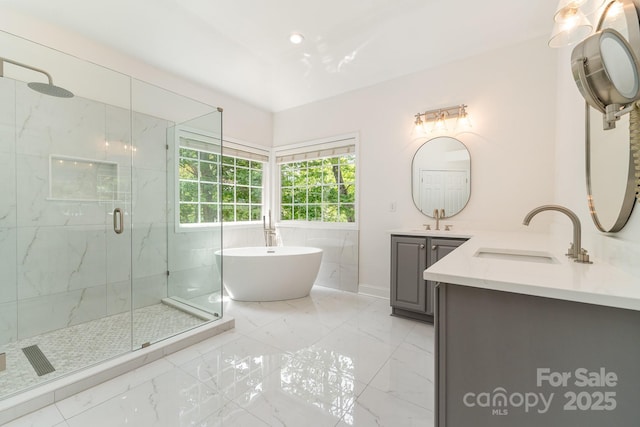 full bath featuring vanity, marble finish floor, baseboards, a freestanding bath, and a marble finish shower