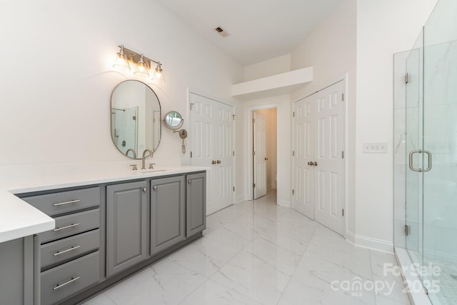 bathroom featuring vanity, a stall shower, marble finish floor, and visible vents