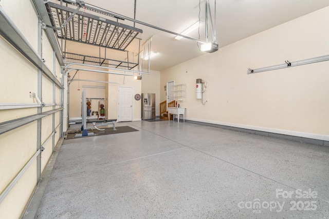 garage with stainless steel fridge with ice dispenser, baseboards, and a garage door opener