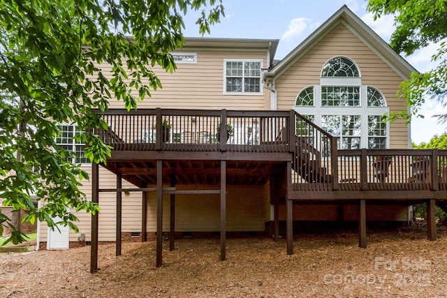 back of house with a deck and crawl space