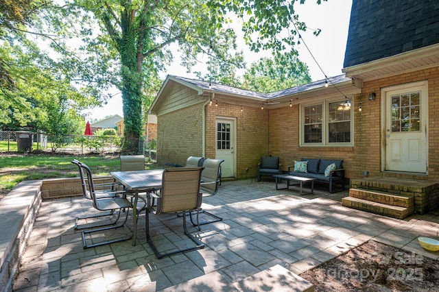 view of patio with fence, outdoor dining space, an outdoor living space, and entry steps