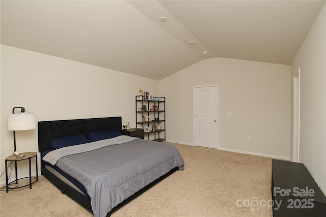 bedroom featuring baseboards, vaulted ceiling, and carpet