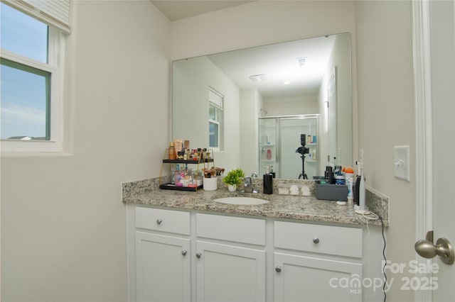 bathroom with vanity and a stall shower
