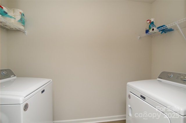 laundry room featuring baseboards, laundry area, and washing machine and dryer
