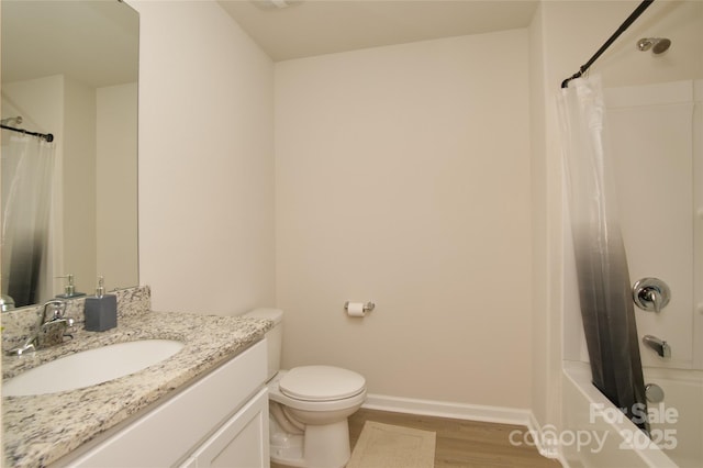 bathroom featuring vanity, toilet, shower / bath combination with curtain, baseboards, and wood finished floors