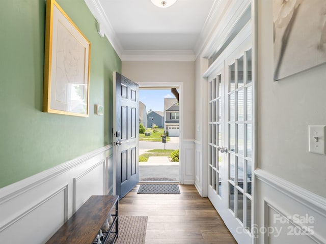 4316 Falls Lake Dr SW, Concord, NC 28025 - entryway with french doors, ornamental molding, a decorative wall, wainscoting, and wood finished floors
