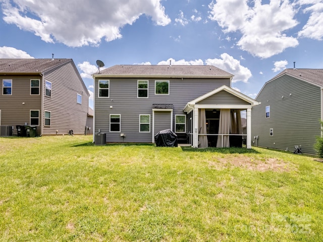 4316 Falls Lake Dr SW, Concord, NC 28025 - back of house featuring a sunroom, central AC unit, and a yard