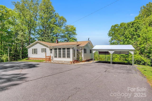 2196 Uphill Ln, Lenoir, NC 28645 - view of front of house with a carport, asphalt driveway, and a chimney