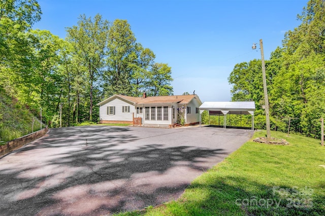 2196 Uphill Ln, Lenoir, NC 28645 - view of front facade with a carport, driveway, a chimney, and a front lawn