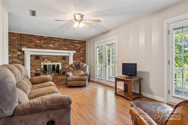 2196 Uphill Ln, Lenoir, NC 28645 - living area with ceiling fan, light wood finished floors, healthy amount of natural light, a textured ceiling, and baseboards