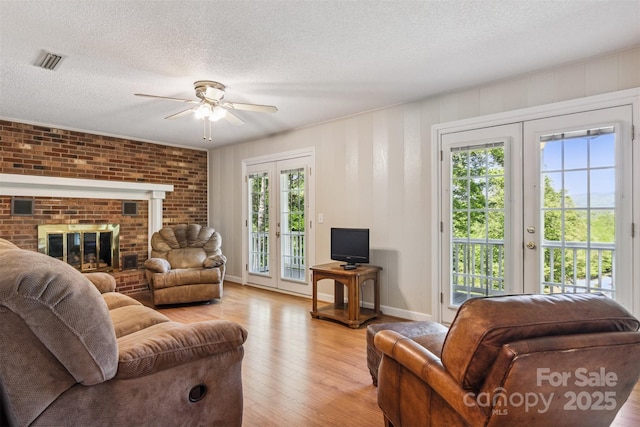 2196 Uphill Ln, Lenoir, NC 28645 - living area with ceiling fan, french doors, light wood-type flooring, a textured ceiling, and baseboards