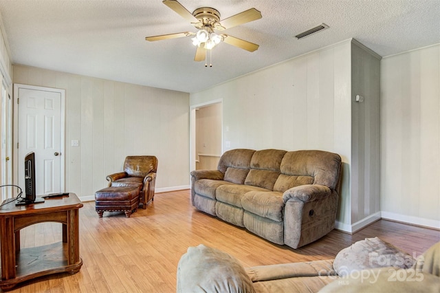 2196 Uphill Ln, Lenoir, NC 28645 - living room with light wood-style floors, ceiling fan, and a textured ceiling