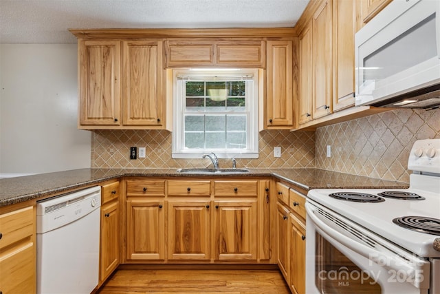 2196 Uphill Ln, Lenoir, NC 28645 - kitchen with white appliances, a sink, light wood-style flooring, decorative backsplash, and a textured ceiling