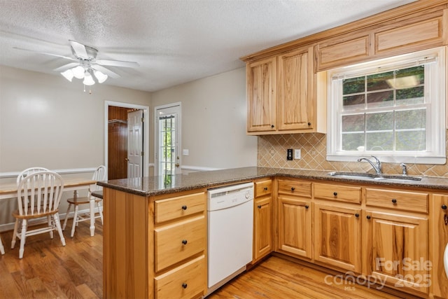 2196 Uphill Ln, Lenoir, NC 28645 - kitchen with white dishwasher, a sink, ceiling fan, light wood-type flooring, and a textured ceiling