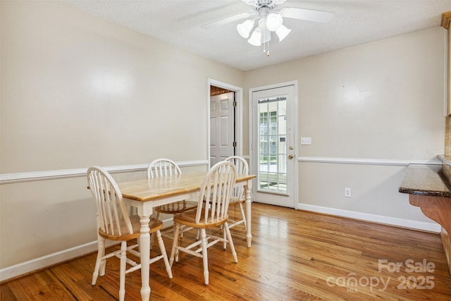 2196 Uphill Ln, Lenoir, NC 28645 - dining room featuring a ceiling fan, light wood-type flooring, and baseboards