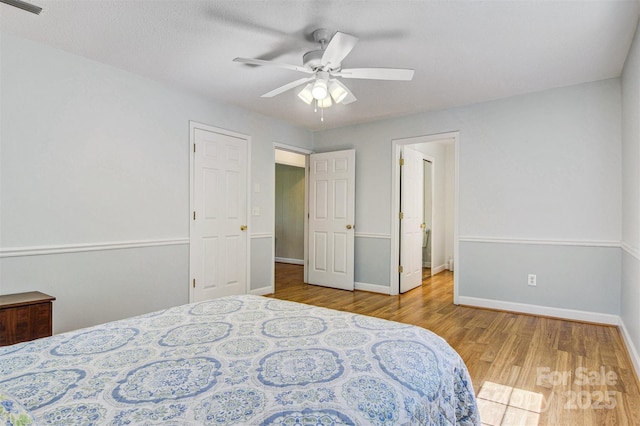 2196 Uphill Ln, Lenoir, NC 28645 - bedroom with wood finished floors, baseboards, and a ceiling fan