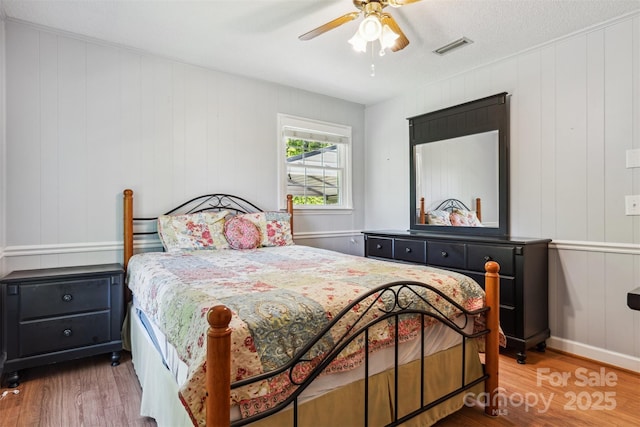 2196 Uphill Ln, Lenoir, NC 28645 - bedroom with wood finished floors, a ceiling fan, and a decorative wall