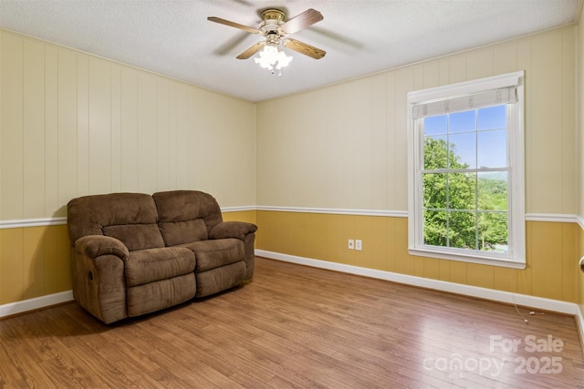 2196 Uphill Ln, Lenoir, NC 28645 - sitting room featuring wood finished floors, ceiling fan, a textured ceiling, and baseboards