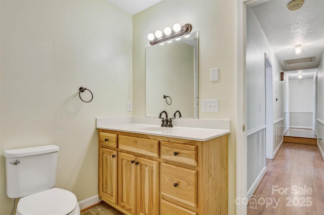 2196 Uphill Ln, Lenoir, NC 28645 - bathroom with toilet, vanity, wood finished floors, and baseboards