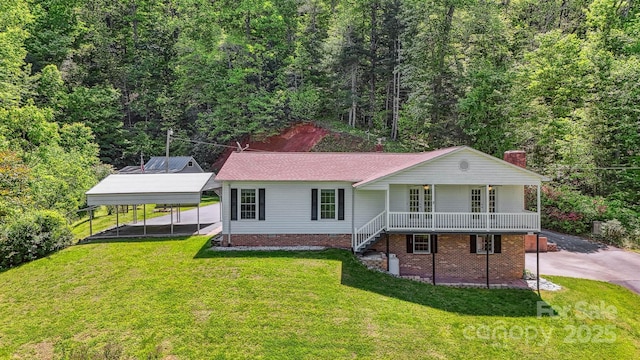 2196 Uphill Ln, Lenoir, NC 28645 - back of house with a detached carport, a lawn, a chimney, and a view of trees