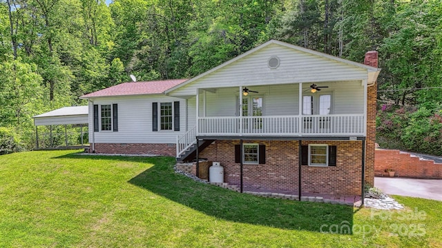2196 Uphill Ln, Lenoir, NC 28645 - view of front facade featuring ceiling fan, a front lawn, a chimney, a carport, and stairs