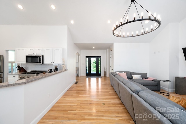 44 White Thorn Dr, Alexander, NC 28701 - living area with arched walkways, a chandelier, recessed lighting, baseboards, and light wood-type flooring