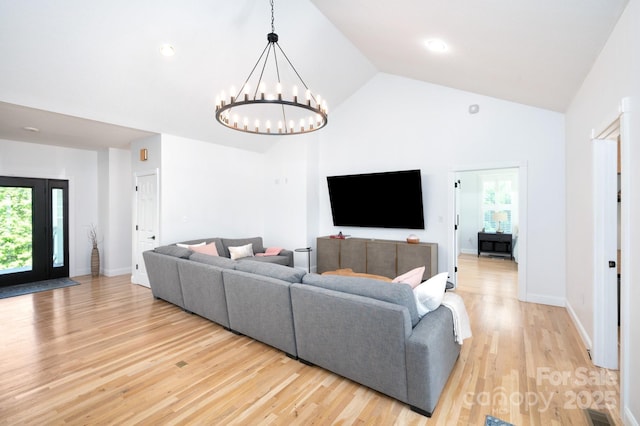 44 White Thorn Dr, Alexander, NC 28701 - living room with high vaulted ceiling, a chandelier, a healthy amount of sunlight, and light wood-style floors