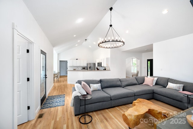 44 White Thorn Dr, Alexander, NC 28701 - living area featuring arched walkways, high vaulted ceiling, an inviting chandelier, recessed lighting, and light wood-style flooring