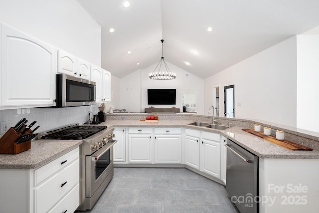 44 White Thorn Dr, Alexander, NC 28701 - kitchen with a sink, light tile patterned floors, lofted ceiling, an inviting chandelier, and stainless steel appliances