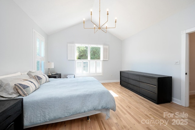 44 White Thorn Dr, Alexander, NC 28701 - bedroom with baseboards, an inviting chandelier, light wood-style flooring, and lofted ceiling