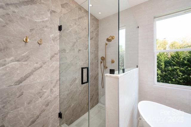 44 White Thorn Dr, Alexander, NC 28701 - bathroom featuring tile walls, a freestanding bath, and a shower stall