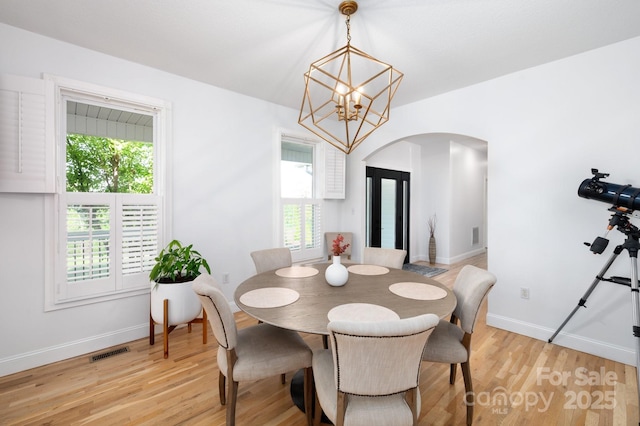 44 White Thorn Dr, Alexander, NC 28701 - dining room featuring visible vents, arched walkways, plenty of natural light, and an inviting chandelier