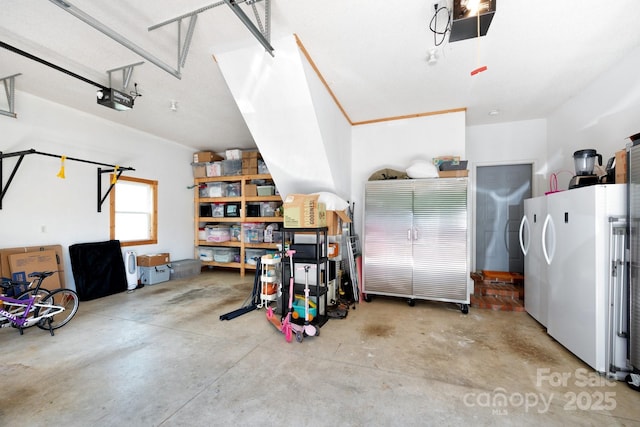 44 White Thorn Dr, Alexander, NC 28701 - garage featuring a garage door opener and freestanding refrigerator