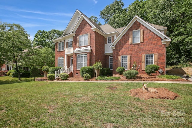 view of front of home featuring a front lawn and brick siding