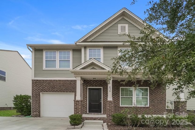 view of front facade featuring brick siding, an attached garage, and concrete driveway