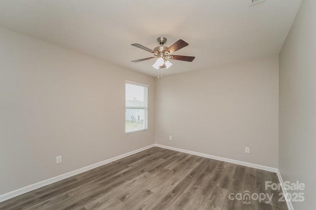 spare room with wood finished floors, baseboards, and ceiling fan