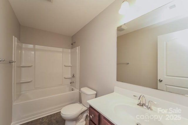 bathroom featuring toilet, vanity, and shower / bathtub combination